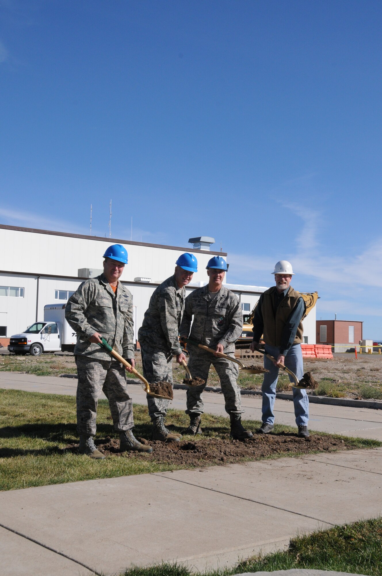 Lt. Col. Buel Dickson, 120th Maintenance Group commander; Col. J. Peter Hronek, 120th Airlift Wing commander; Lt. Col. Frederyck Cayer,120th Civil Engineer commander and John Engebretsen, James Talcott Construction project manager, break ground at the C-130 consolidated maintenance hangar construction site at the 120th Airlift Wing Oct. 17.  Construction of the hangar is expected to take one year. (Montana Air National Guard photo/Maj. Cody Smith) 
