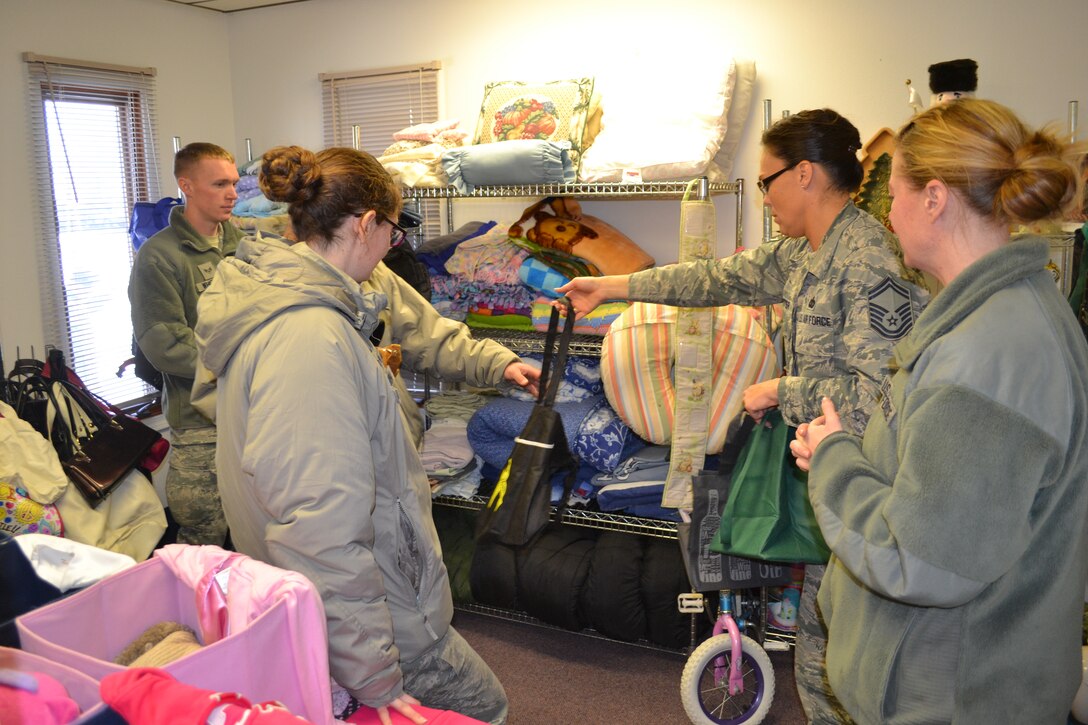 120th Airlift Wing Airmen shop for free bargains at the new Airman’s Attic that opened on base Dec. 6, 2014. The program will be ran jointly by members of the Montana Air National Guard Airman and Family Readiness Program and the Junior Enlisted Council and offers free clothing and household items donated to the program by members of the Montana Air National Guard. Air National Guard photo by Senior Master Sgt. Eric Peterson.