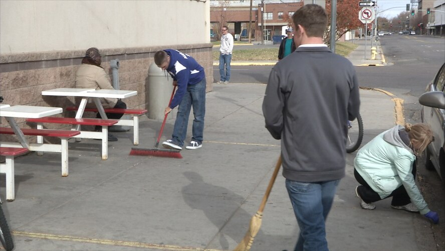 Airmen from the 120th Airlift Wing student flight sweep the sidewalk outside the Great Falls Rescue Mission Nov. 1 as part of their drill weekend activities. (Montana Air National photo/Senior Airman Nikolas Asmussen)