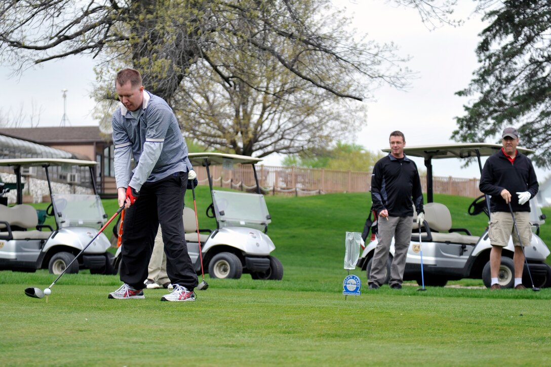 U.S. Air Force Capt. Ken Hornsby, 557th Weather Wing, focuses on his ball before he swings during the Sexual Assault Awareness and Prevention Month golf tournament at Willow Lakes April 29, Offutt Air Force Base, Neb. The tournament, held with the assistance of the 1st Sergeants Group, was just one of many events held throughout the month designed to raise awareness and combat sexual assault. (U.S. Air Force photo by Jeff W. Gates/Released)
