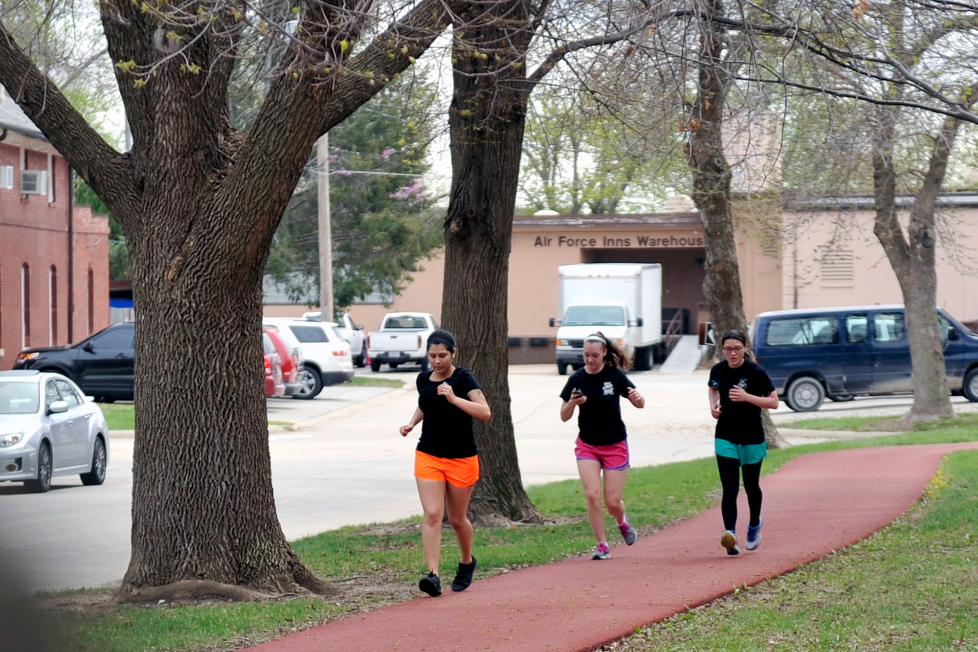 A group of runners head down Washington Square of the parade grounds during the Sexual Assault Awareness and Prevention Month 5k relay race April 17, Offutt Air Force Base, Neb. The race was just one of many events held throughout the month designed to raise awareness and combat sexual assault. (U.S. Air Force photo by Jeff W. Gates/Released)
