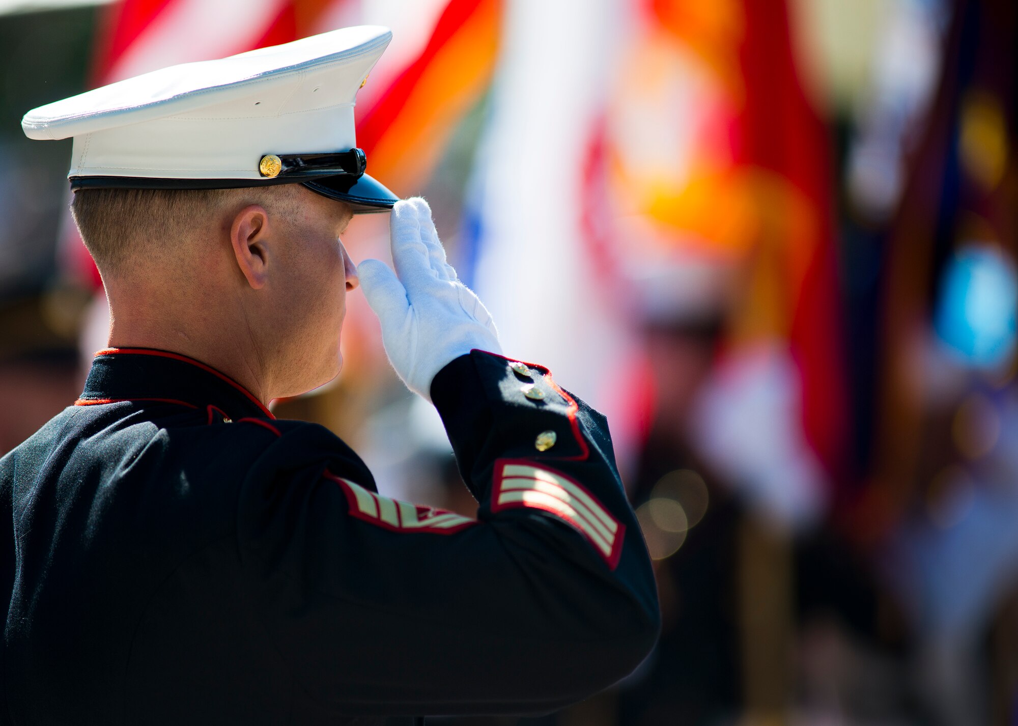 Gunnery Sgt. Jeremy Rash, the master of ceremony, salutes during the National Anthem at the Explosive Ordnance Disposal’s 46th Annual Memorial Service at the Kauffman EOD Training Complex at Eglin Air Force Base, Fla., May 2.  Eight names of Army, Marine and Navy service members were added to the EOD memorial wall. The all-service total now stands at 314. (U.S. Air Force photo/Tech. Sgt. Samuel King Jr.) 