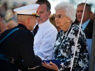Marine Corps Lt. Gen. William Faulkner, deputy commandant of installations and logistics, presents a folded flag to Eleanor Swiger, the sister of Cpl. Clellie Whited Jr., during the Explosive Ordnance Disposal’s 46th Annual Memorial Service at the Kauffman EOD Training Complex at Eglin Air Force Base, Fla., May 2.  Whited died while serving in a bomb disposal unit in World War II. Eight names of Army, Marine and Navy service members were added to the EOD memorial wall. The all-service total now stands at 314.  (U.S. Air Force photo/Tech. Sgt. Samuel King Jr.)