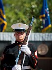 A Marine member of the joint-service color guard stands in front of the Explosive Ordnance Disposal Memorial Wall during the 46th Annual Memorial Service at the Kauffman EOD Training Complex at Eglin Air Force Base, Fla., May 2.  Eight names of Army, Marine and Navy service members were added to the EOD memorial wall. The all-service total now stands at 314.  (U.S. Air Force photo/Tech. Sgt. Samuel King Jr.)