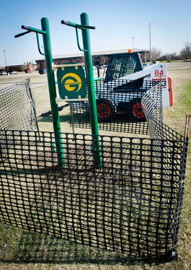 A set of pull up bars rest in the ground on Minot Air Force Base, N.D., April 23, 2015. The pull up bars were a portion of new gym equipment slated to be installed by the outdoor track at the McAdoo Fitness Center. (U.S. Air Force photo/Airman 1st Class Sahara L. Fales)
