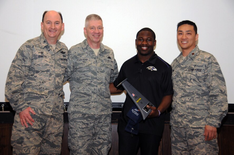 Colonel Thomas K. Smith Jr., commander, 459th Air Refueling Wing, Chief Master Sgt. Tim Huffman, 459 ARW Command Chief, and Chaplain (Maj.) Joshua Kim, 459 ARW Wing Chaplain pose in a photo with Justin Forsett, Baltimore Ravens running back at the first prayer breakfast in the 459 wing auditorium at Joint Base Andrews, Md., May 2, 2015.  Forsett was the guest speaker for the event. (U.S. Air Force photo/ Tech. Sgt. Brent Skeen)