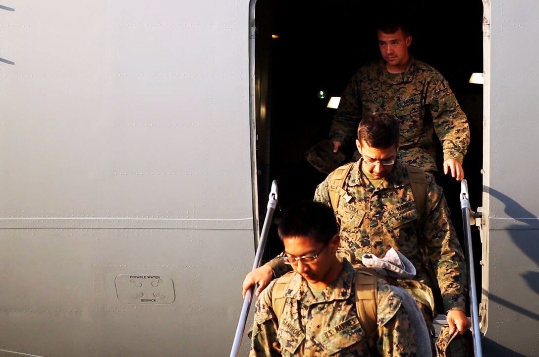 U.S. Marines Lance Cpl. Jacob A. Miller, top, Cpl. Garrett Gloska and Cpl. Eugene Ganiron, step off a Boeing C-17 Globemaster III onto Tribhuvan International Airport in Kathmandu, Nepal, May 3, 2015. The Marines brought a UH-1Y Huey, tools and equipment to support the Nepalese government's request for help after a magnitude-7.8 earthquake, April 25.