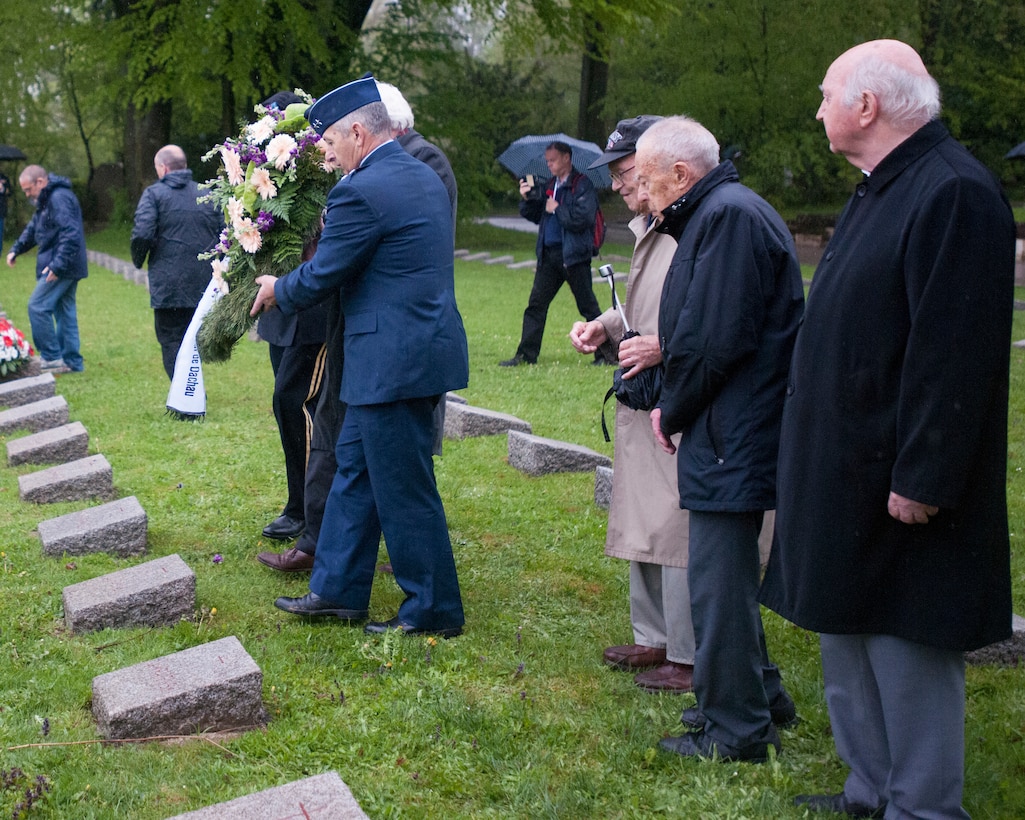 U.S. Air Force Maj. Gen. H. Michael Edwards, the adjutant general for Colorado; and U.S. Army Maj. Gen. Robbie L. Asher, the adjutant general for Oklahoma; lay a wreath in the Waldfriedhof Cemetery as part of activities honoring the 70th anniversary of the liberation of prisoners of the Dachau concentration camp during World War II in Munich, Germany, May 1, 2015.