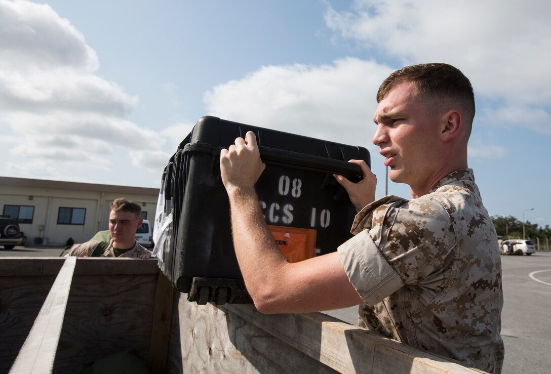 U.S. Marine Lance Cpl. Austin Baker helps palletize luggage on Kadena Air Base, Okinawa, Japan, May 4, 2015, before a fligh to Nepal.
