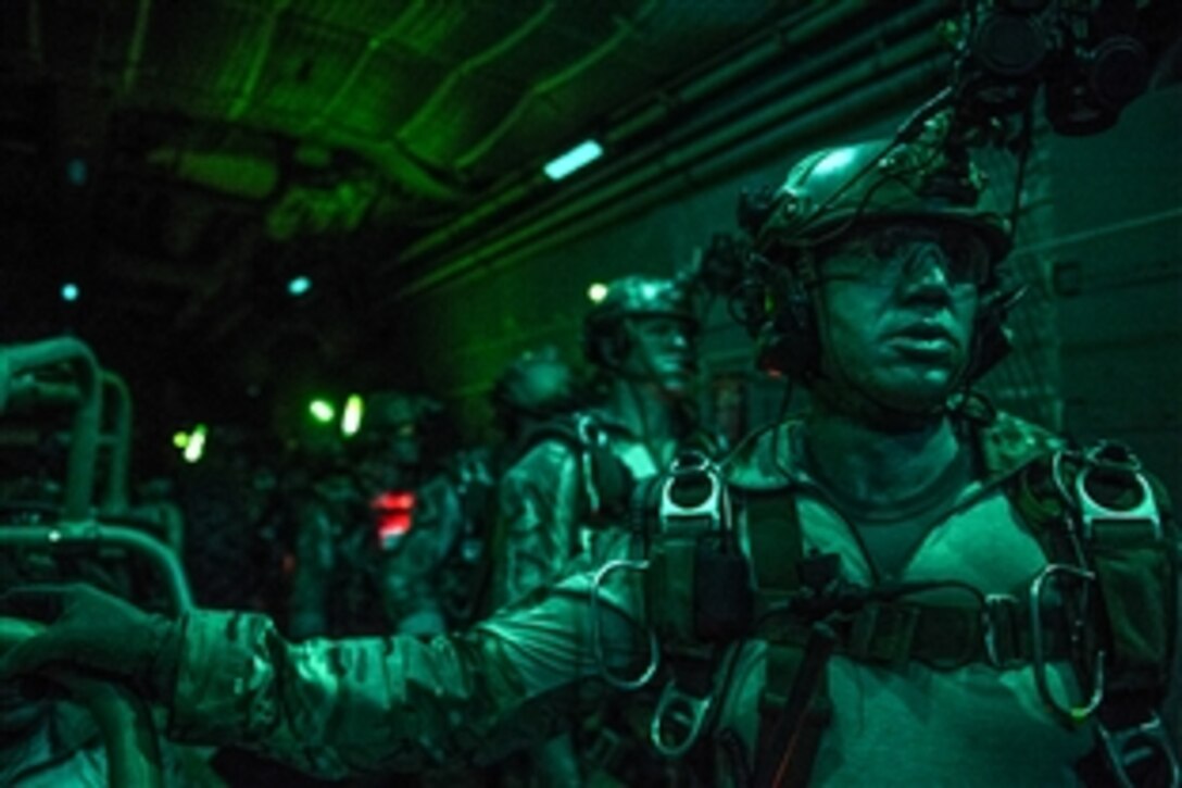 Air Force combat controllers prepare to free fall from an MC-130H Combat Talon II during Emerald Warrior over Marianna Municipal Airport, Fla., April 29, 2015. The combat controllers are assigned to 21st Special Tactics Squadron.
