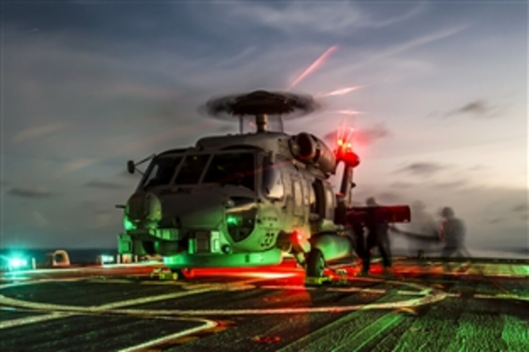 U.S. sailors refuel an MH-60R Seahawk helicopter on the flight deck of the littoral combat ship USS Fort Worth in the South China Sea, April 30, 2015. The MH-60R is assigned to Helicopter Maritime Strike Squadron 35.

