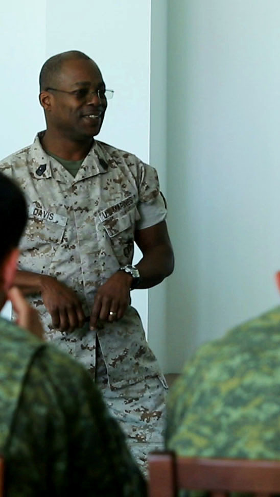 U.S. Marine Master Gunnery Sgt. Clarence Davis, operations chief for Black Sea Rotational Force, discusses command and control and the combat operations center with members of the Kosovo Security Force.  Approximately 65 KSF members and nine U.S. Marines participated in three military-to-military engagments at Camp Adem Jashari in Pristina, April 14-24, 2015. (Official Marine Corps photo by 1st Lt. Sarah E. Burns)