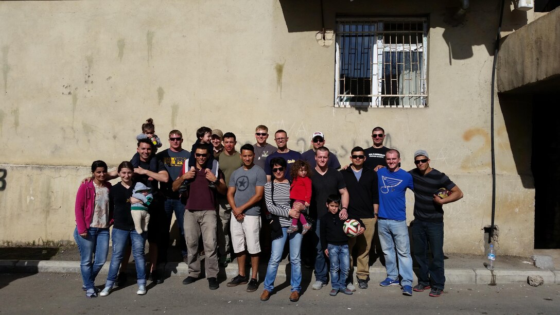 The Marines, women and children of KERA women's shelter take a group photo before saying goodbye. Marines of Georgia Deployment Program-Resolute Support Mission volunteered their time at KERA’s Women Shelter to help improve and maintain robust relationships with their local community while abroad.