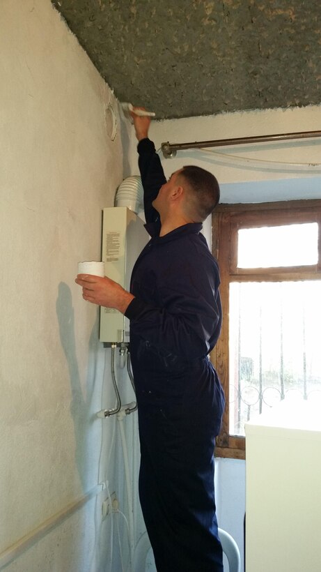 Staff Sergeant Jonathan A. Patton, the GDP-RSM data chief, helps paints the shelter's kitchen. The Marines donated their time, as well as the supplies and materials required to paint the kitchen. Marines of Georgia Deployment Program-Resolute Support Mission volunteered their time at KERA’s Women Shelter to help improve and maintain robust relationships with their local community while abroad.