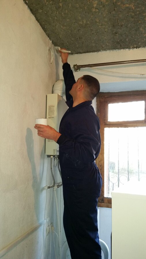 Staff Sergeant Jonathan A. Patton, the GDP-RSM data chief, helps paints the shelter's kitchen. The Marines donated their time, as well as the supplies and materials required to paint the kitchen. Marines of Georgia Deployment Program-Resolute Support Mission volunteered their time at KERA’s Women Shelter to help improve and maintain robust relationships with their local community while abroad.
