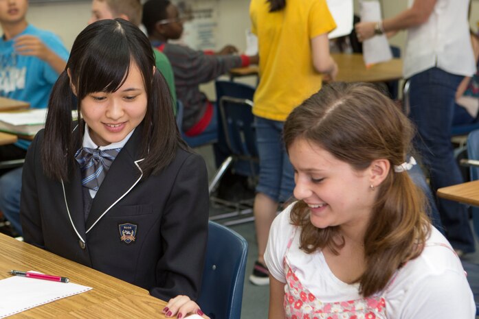 Students from the Matthew C. Perry High School and Noda Gakuen High School bond during a mathematics class while a visiting M.C. Perry aboard Marine Corps Air Station Iwakuni, Japan, April 24, 2015. The visit is part of the Noda Gakuen High School’s Global International Course, thats main focus is to give students resources needed to improve language and communication skills, understand their roles in different societies and actively challenge themselves to try new things.
