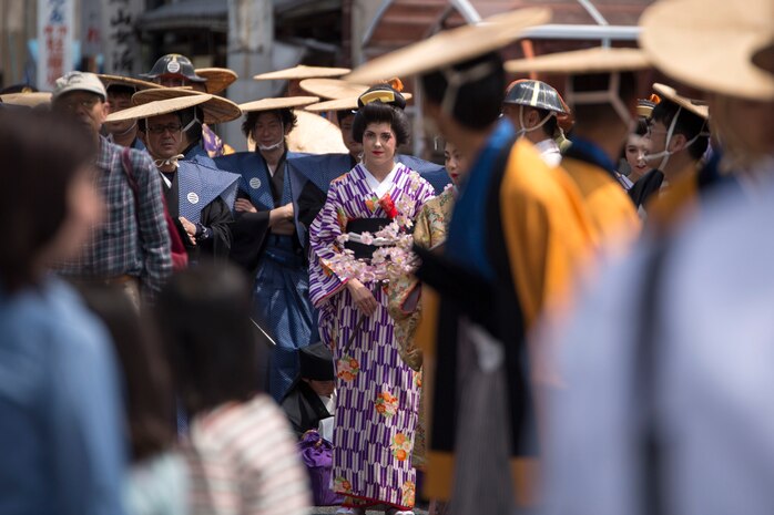 Cpl. Alissa P. Schuning, the social media noncommissioned officer with the Public Affairs Office aboard Marine Corps Air Station Iwakuni, Japan, walks in the Daimyo Procession during the 38th Annual Kintai-kyo Bridge Festival, in Iwakuni City, April 29, 2015. The procession is an annual parade that reenacts the return of a daimyo, one of the most powerful feudal rulers who is subordinate only to the shogun and his entourage from the capital of Japan.