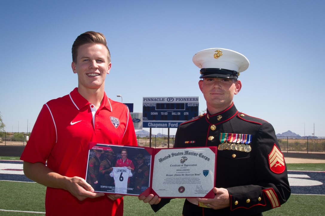 U.S. Marine Corps Sgt. Sterling Hagan and Arizona Marines recognize Pinnacle High School senior football standout quarterback Brian Lewerke, April 29, 2015, at Pinnacle H.S. in Phoenix, for his participation in the 2015 Semper Fidelis All-American Bowl. Lewerke maintains a 4.3 grade point average and capped his high school football career with 2,469 passing yards, 34 passing touchdowns, 998 rushing yards, and 12 rushing touchdowns during his senior season. Lewerke will attend Michigan State University in the fall where he will continue his football career. (U.S. Marine Corps photo by Sgt. Tyler J. Bolken)