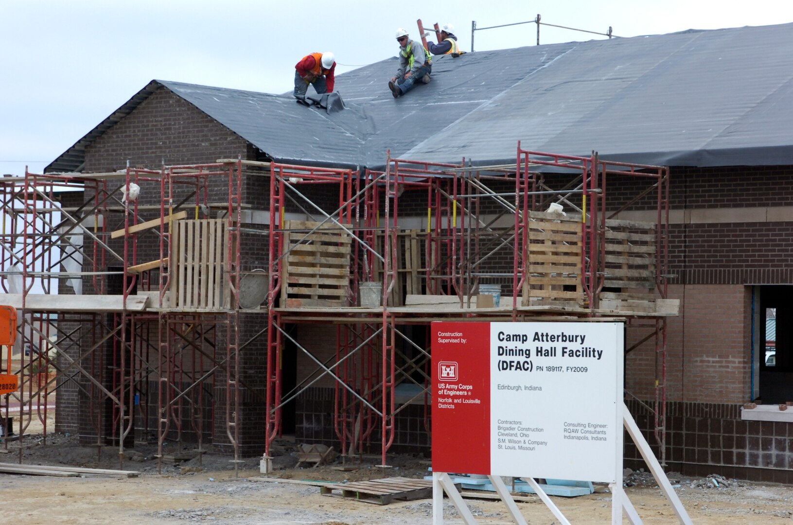 Construction workers putting the roof on the new dinning facility at Camp Atterbury Joint Maneuver Training Center, Ind. The new dinning facility is part of an aggressive construction program to expand the capabilities of Camp Atterbury.