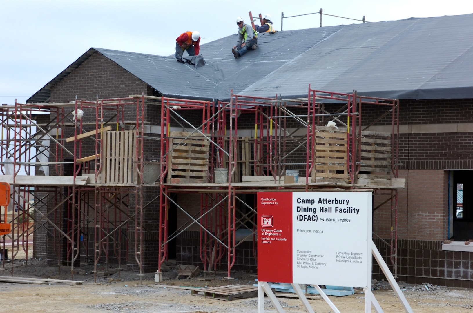 Construction workers putting the roof on the new dinning facility at Camp Atterbury Joint Maneuver Training Center, Ind. The new dinning facility is part of an aggressive construction program to expand the capabilities of Camp Atterbury.