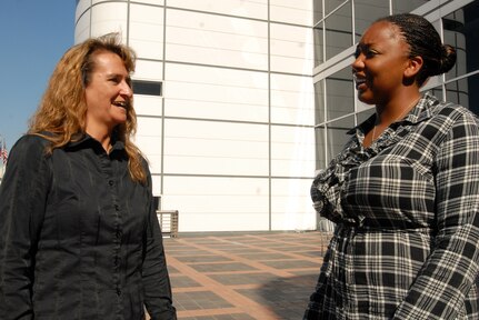 Army Sgt. 1st Class Karen Perry, left, catches up with her battle buddy, Army Sgt. Annika Chambers, during a Yellow Ribbon Reintegration Program post-deployment event in Houston, Oct. 17, 2010. The program aims to equip Guard and Reserve members with the skills they need to successfully transition back to their families, communities and jobs.