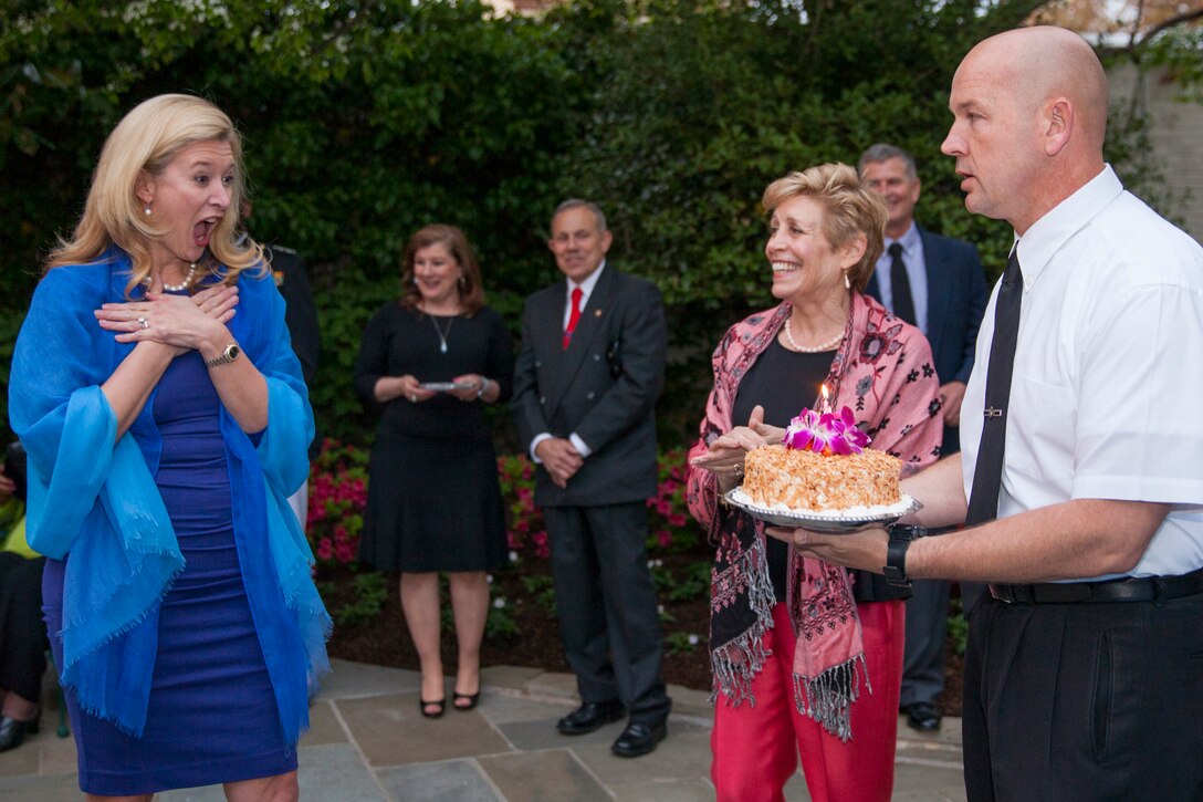 Lynne Mabus, wife of the Honorable Ray Mabus, 75th secretary of the U.S. Navy, receives a cake in honor of her birthday during an evening parade reception at the Home of the Commandants, Washington, D.C., May 1, 2015. The parades, which are held Friday nights during the summer months, are a means of honoring senior officials, distinguished citizens, and supporters of the U.S. Marine Corps. (U.S. Marine Corps photo by Lance Cpl. Alejandro Sierras/ Released) 
