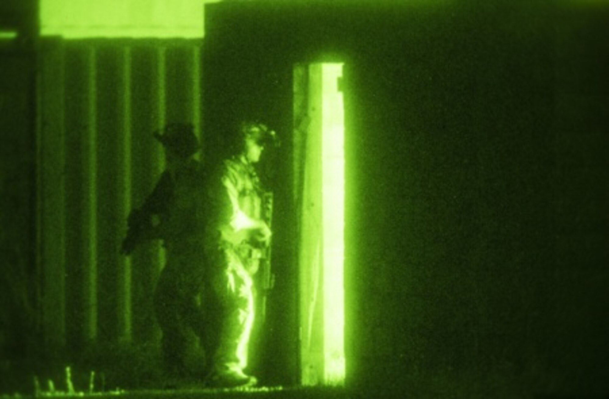 Navy SEAL team members prepare to breach a doorway during an Emerald Warrior close quarters combat exercise near Hurlburt Field, Fla., April 28, 2015. Emerald Warrior is the Defense Department's only irregular warfare exercise, allowing joint and combined partners to train together and prepare for real-world contingency operations. (U.S. Air Force photo/Senior Airman Cory D. Payne)