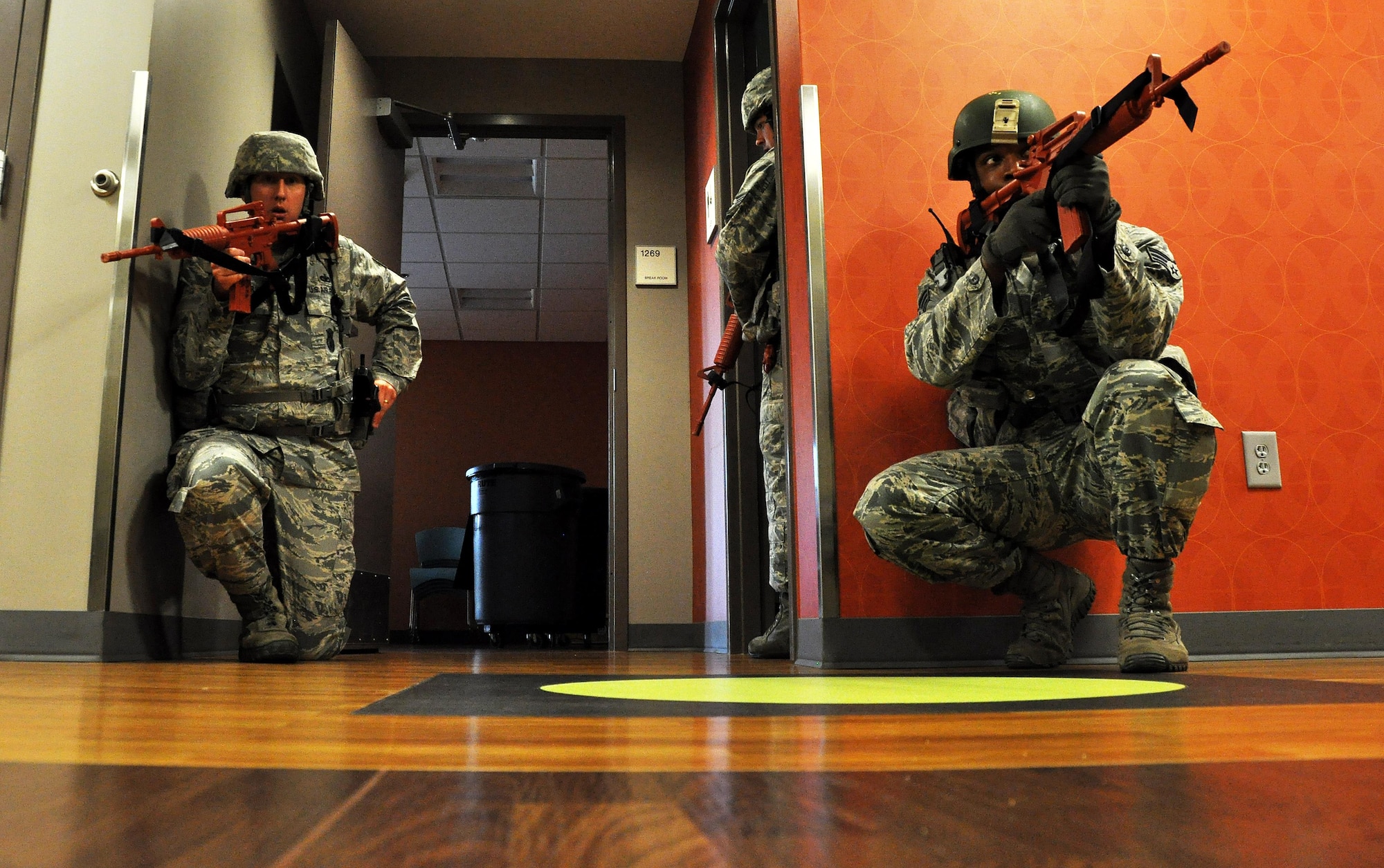 Tech. Sgt. Richard Potter and Senior Airman Gerald Jordan, 94th Security Forces Squadron members, provide over sight for their fellow Defenders as they sweep through rooms of the 94th Aeromedical Staging Squadron searching for any potential threats after taking down the active shooter during a training exercise April 23, 2015, at Dobbins Air Reserve Base, Ga. The 94th SFS provides active shooter training throughout the year and for individual units and organizations on the base to be better prepared for a real-world incident. (U.S. Air Force photo/Senior Airman Daniel Phelps)