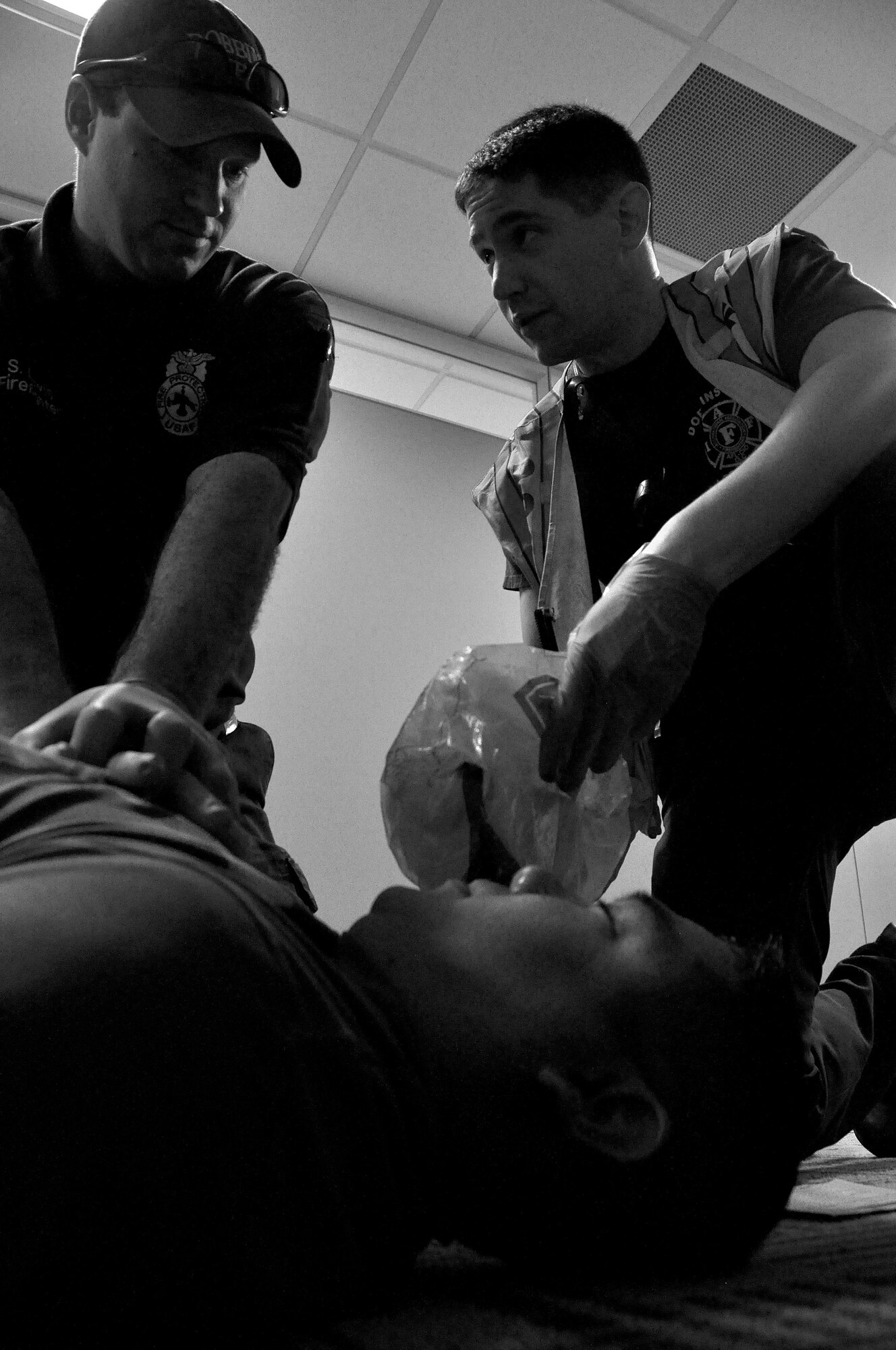 Scott Lewis and David Christensen, Dobbins Firefighters, check the vitals of a “casualty” during an active shooter training exercise April 23, 2015, at Dobbins Air Reserve Base, Ga. The purpose of the active shooter exercise was a follow-on to a table top exercise held in May last year. (U.S. Air Force photo/Senior Airman Daniel Phelps)
