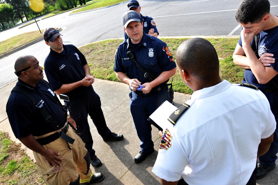 Dobbins Firefighters debrief once the active shooter exercise comes to a close to analyze their performance April 23, 2015, at Dobbins Air Reserve Base, Ga. The point of this exercise was to test the interoperability of Dobbins and Cobb County and to ensure mission partners were aware of what their role in a scenario like this would be. (U.S. Air Force photo/Senior Airman Daniel Phelps)