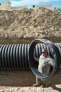 Pvt. Matt Tetzlaff works on an underground tunnel system during construction of the Counter Improvised Explosive Device Village, at the Wyoming National Guard's Camp Guernsey Joint Training Center in Guernsey, Wyo., Oct. 5, 2010. The village is being constructed at a cost of $1.5 million and will include a prison complex, hidden passageways, false walls, pop-up targets, and adjacent counter IED walking paths and roadways. The project is on track to be fully operational by the spring of 2011.