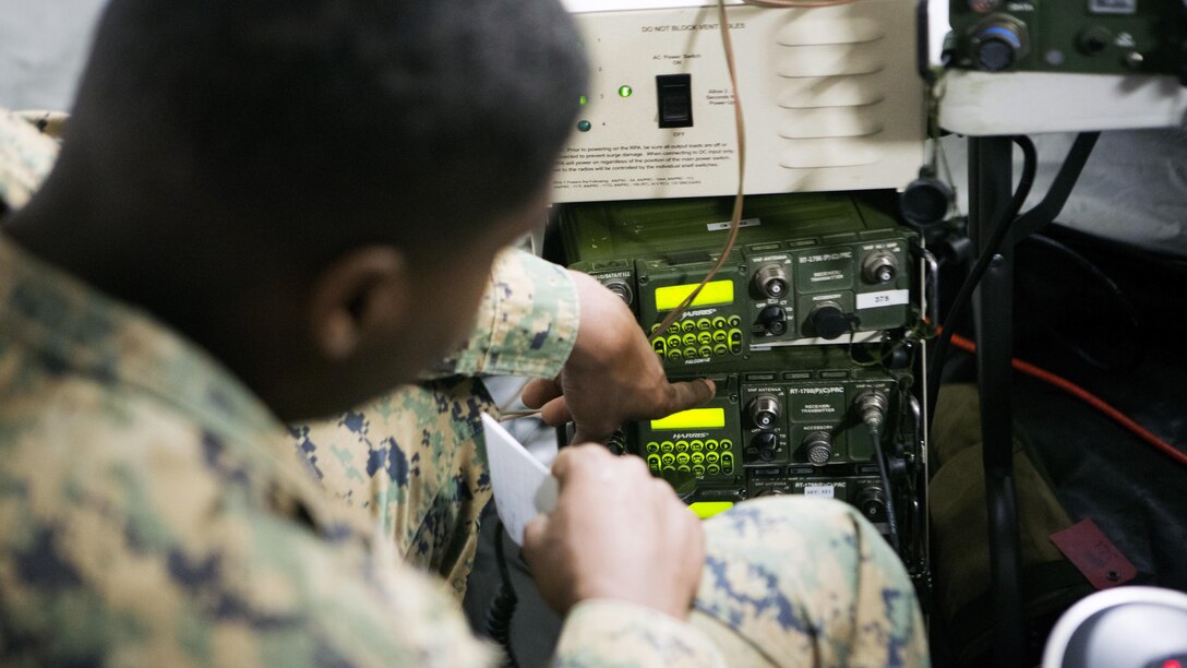 Cpl. Justin McKenzi, a radio operator with 1st Air Naval Gunfire Liaison Company checks multiple radio frequencies to prepare for Exercise Maple Resolve 15 at Canadian Maneuver Training Center, Camp Wainwright, Alberta April 30, 2015. The exercise allowed the Marines to test new equipment and establish a knowledge platform for future operations.