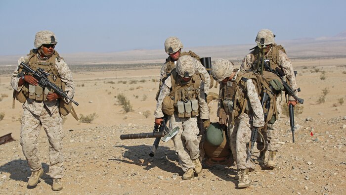 Marines with Ground Combat Element Integrated Task Force, conduct a simulated casualty evacuation during a Marine Corps Operational Test and Evaluation Activity assessment at Range 107, Marine Corps Air Ground Combat Center Twentynine Palms, California, April 23, 2015. From October 2014 to July 2015, the GCEITF will conduct individual and collective level skills training in designated ground combat arms occupational specialties in order to facilitate the standards-based assessment of the physical performance of Marines in a simulated operating environment performing specific ground combat arms tasks.
