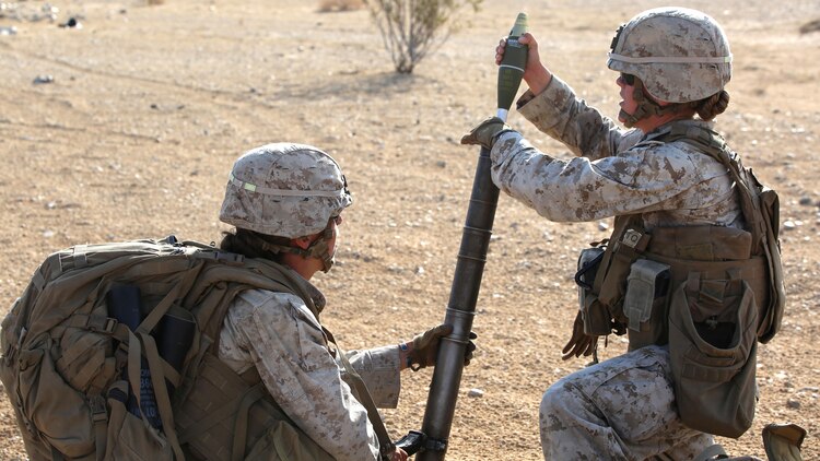 Sgt. Rebecca Rutherford, right, mortar man, with Ground Combat Element Integrated Task Force, loads an M224 60mm light-weight mortar with the assistance of Cpl. Jacklyn Dean, left, with GCEITF, during a Marine Corps Operational Test and Evaluation Activity assessment at Range 107, Marine Corps Air Ground Combat Center Twentynine Palms, California, April 23, 2015. From October 2014 to July 2015, the GCEITF will conduct individual and collective level skills training in designated ground combat arms occupational specialties in order to facilitate the standards-based assessment of the physical performance of Marines in a simulated operating environment performing specific ground combat arms tasks. 