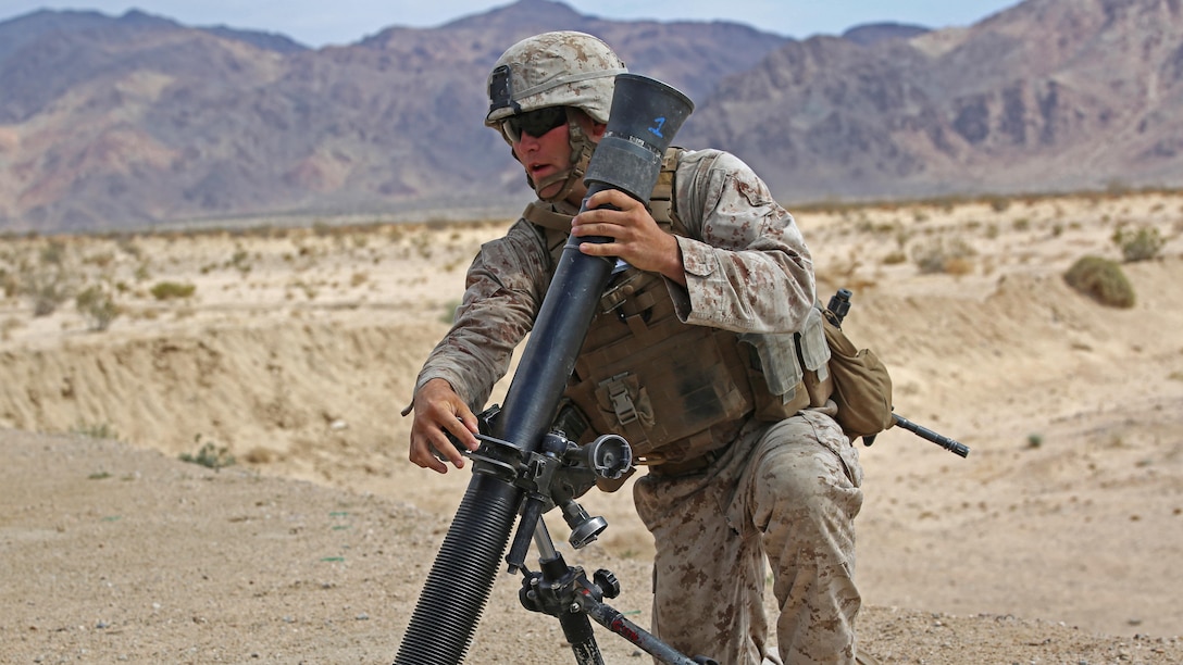 Sgt. Dustin Houghton, mortar man, with Ground Combat Element Integrated Task Force, secures an M252 81mm medium-weight mortar during a Marine Corps Operational Test and Evaluation Activity assessment at Range 107, Marine Corps Air Ground Combat Center Twentynine Palms, California, April 24, 2015. From October 2014 to July 2015, the GCEITF will conduct individual and collective level skills training in designated ground combat arms occupational specialties in order to facilitate the standards-based assessment of the physical performance of Marines in a simulated operating environment performing specific ground combat arms tasks.
