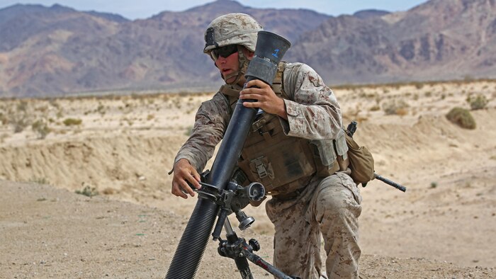 Sgt. Dustin Houghton, mortar man, with Ground Combat Element Integrated Task Force, secures an M252 81mm medium-weight mortar during a Marine Corps Operational Test and Evaluation Activity assessment at Range 107, Marine Corps Air Ground Combat Center Twentynine Palms, California, April 24, 2015. From October 2014 to July 2015, the GCEITF will conduct individual and collective level skills training in designated ground combat arms occupational specialties in order to facilitate the standards-based assessment of the physical performance of Marines in a simulated operating environment performing specific ground combat arms tasks.