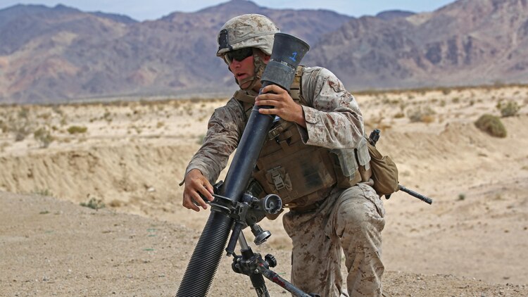 Sgt. Dustin Houghton, mortar man, with Ground Combat Element Integrated Task Force, secures an M252 81mm medium-weight mortar during a Marine Corps Operational Test and Evaluation Activity assessment at Range 107, Marine Corps Air Ground Combat Center Twentynine Palms, California, April 24, 2015. From October 2014 to July 2015, the GCEITF will conduct individual and collective level skills training in designated ground combat arms occupational specialties in order to facilitate the standards-based assessment of the physical performance of Marines in a simulated operating environment performing specific ground combat arms tasks.