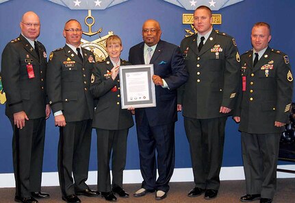 From left to right, Lt. Col. John Holter, the South Dakota Army National Guard operations office, Maj. Bob DeJong, the state's Counterdrug coordinator, Sgt. 1st Class Kristi "Cricket" Palmer of the state's West River Drug Demand Reduction, John Morse, chief functional officer of the TRICARE Management Activity, and Staff Sgts. David Hughes and Matt Hurney, both of the state's East River Drug Demand Reduction accept the Secretary of Defense Community Drug Awareness Award at the Pentagon Hall of Heroes in Washington, D.C., Oct. 22, 2010.