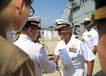 BUSAN, Republic of Korea (May 4, 2015) - Capt. Kurush Morris (right), commanding officer of the Ticonderoga-class guided-missile cruiser USS Shiloh (CG 67), greets a Republic of Korea Navy officer as the ship arrives in Busan. Shiloh is conducting routine patrols and maritime security operations in the U.S. 7th Fleet area of responsibility to promote stability and develop key partnerships with allies across the Indo-Asia-Pacific region. 