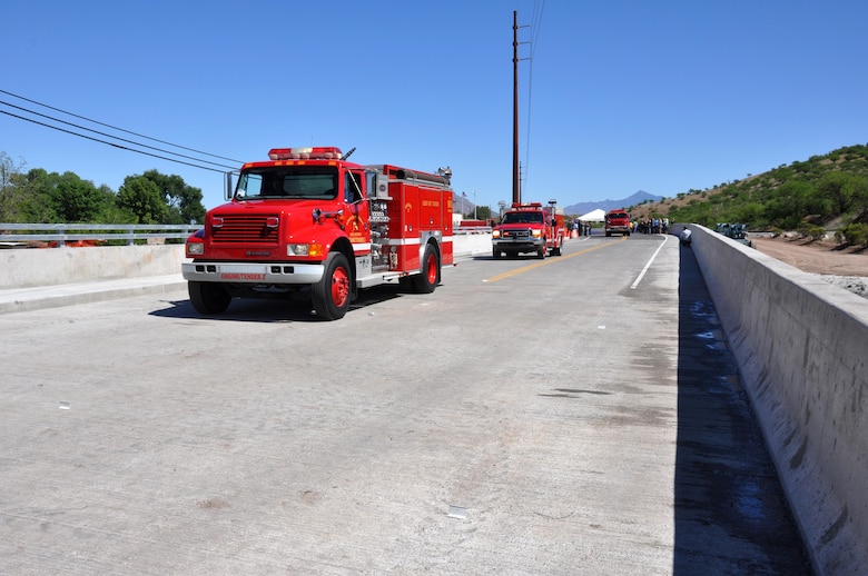 Fire and rescue vehicles from the Nogales Suburban Fire District cross the newly opened Nogales Wash Bridge April 17 in Nogales, Arizona. The U.S. Army Corps of Engineers Los Angeles District constructed the $4 million bridge after the original structure was removed in 2008 as part of a flood control construction project.
