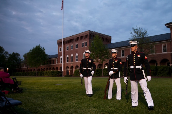 Marines at Marine Barracks Washington, D.C. perform as crowd educators during an evening parade at the Barracks, May 1, 2015. The crowd educators are volunteer Marines who inform the crowds about barracks history and Marine Corps tradition. The parades, which are held Friday nights during the summer months, are a means of honoring senior officials, distinguished citizens, and supporters of the U.S. Marine Corps. (U.S. Marine Corps photo by Lance Cpl. Alejandro Sierras/ Released) 