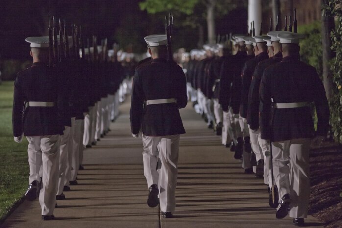 Marines with Company B, Marine Barracks Washington, D.C. march across troop walk during the evening parade, May 1, 2015. The parades, which are held Friday nights during the summer months, are a means of honoring senior officials, distinguished citizens, and supporters of the Marine Corps. (U.S. Marine Corps photo by Lance Cpl. Alex A. Quiles/ Released)
