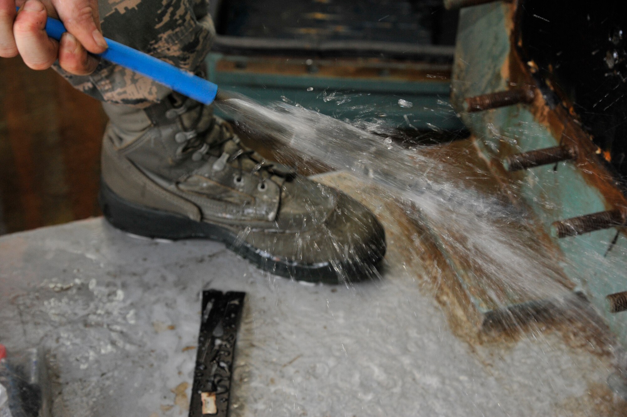 U.S. Air Force Airman 1st Class Coehn Johnson, 35th Civil Engineer Squadron Heating Ventilation and Air Conditioning journeyman, controls a cleaning instrument during summer maintenance at Misawa Air Base, Japan, May 5, 2015. This siphoning tool is used to clean out the inner coils of a chilling unit by rapidly spinning, and is controlled by a foot pedal system, allowing Johnson to advance and reverse the instrument to clean the full length of the coil from the inside. (U.S. Air Force photo by Senior Airman Patrick S. Ciccarone/Released)