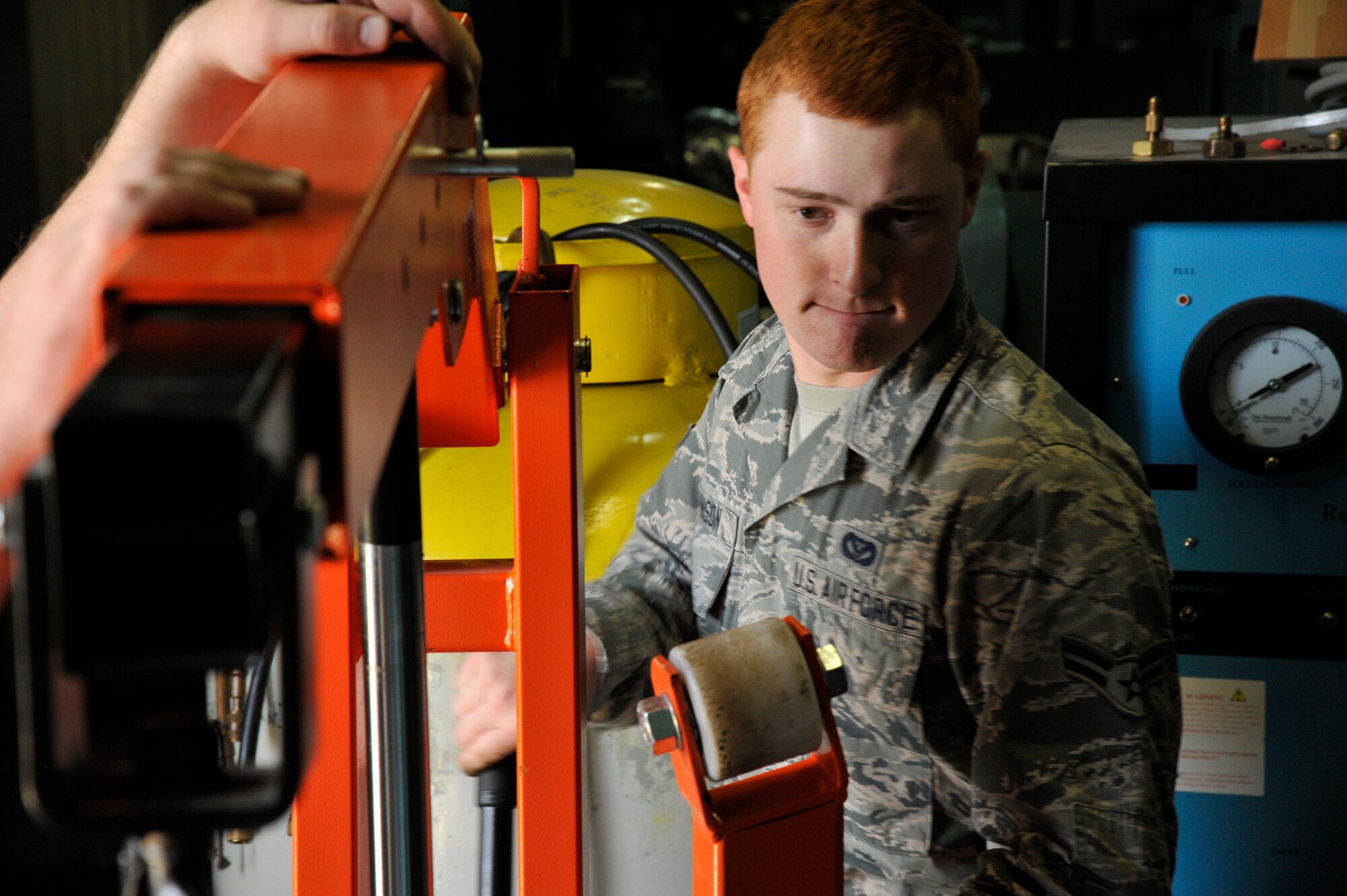 U.S. Air Force Airman 1st Class Coehn Johnson, 35th Civil Engineer Squadron Heating Ventilation and Air Conditioning journeyman, operates a winch during routine maintenance at Misawa Air Base, Japan, May 5, 2015. The winch is used to remove a panel containing a series of coils Johnson and his teammate cleaned out with a boring tool. (U.S. Air Force photo by Senior Airman Patrick S. Ciccarone/Released)