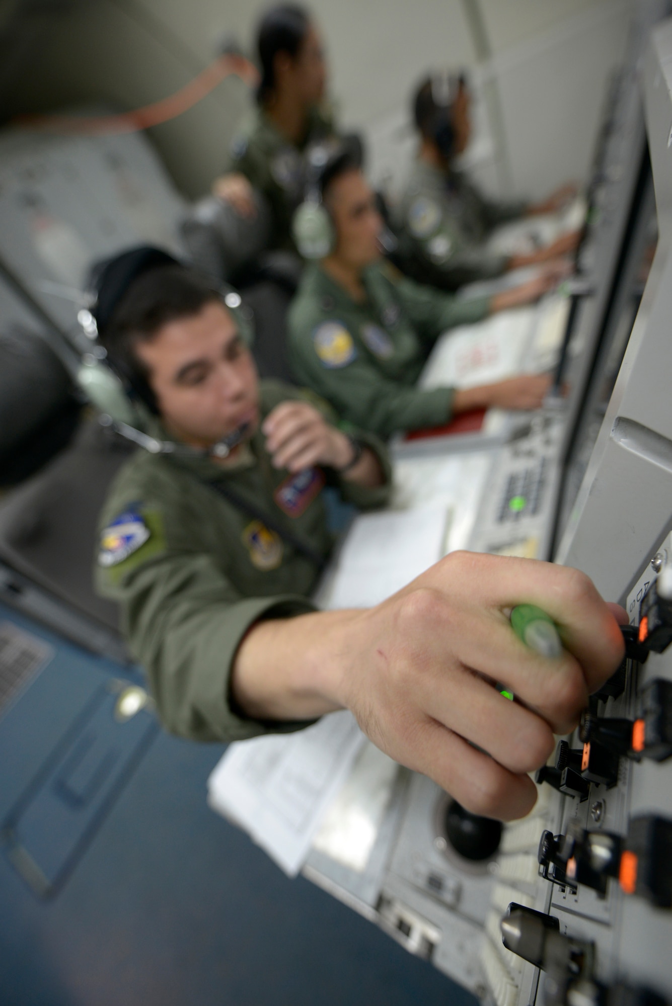 U.S. Air Force 1st Lt. Andrew Stokes, 961st Airborne Air Control Squadron (AACS) air weapons officer, adjusts his display while working alongside Philippine Air Force weapons controllers while onboard a 961st AACS E-3 Sentry Airborne Warning and Control System (AWACS) aircraft during exercise Balikatan 2015 over the Philippines, April 23. This exercise marks the first time in history that PAF air battle managers have controlled other aircraft while onboard the AWACS. Since the exercise began, April 20, the 961st AACS has integrated 20 PAF weapons controllers during their missions in order to provide them with firsthand experience using the aircraft’s systems. The 961st AACS is stationed at Kadena Air Base, Japan. (U.S. Air Force photo by Staff Sgt. Maeson L. Elleman)
