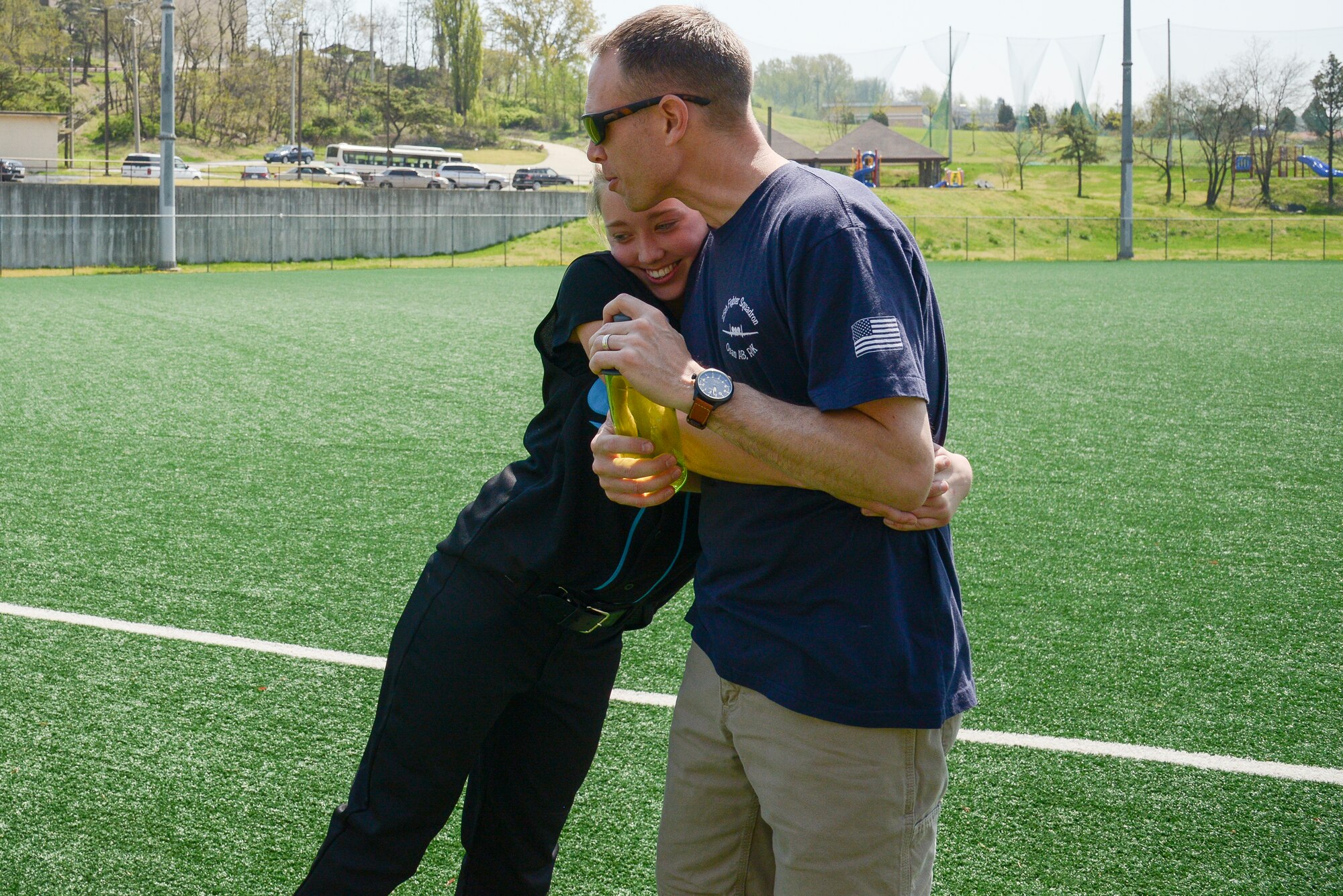 Avery Lokowich gives her dad, Lt. Col. Luke Lokowich, 5th Reconnaissance Squadron commander and a U-2 pilot, a hug after her softball game April 25, 2015, at Osan Air Base, Republic of Korea. Avery is the oldest of the three children that Luke has. (U.S. Air Force photo by Staff Sgt. Jake Barreiro/Released)