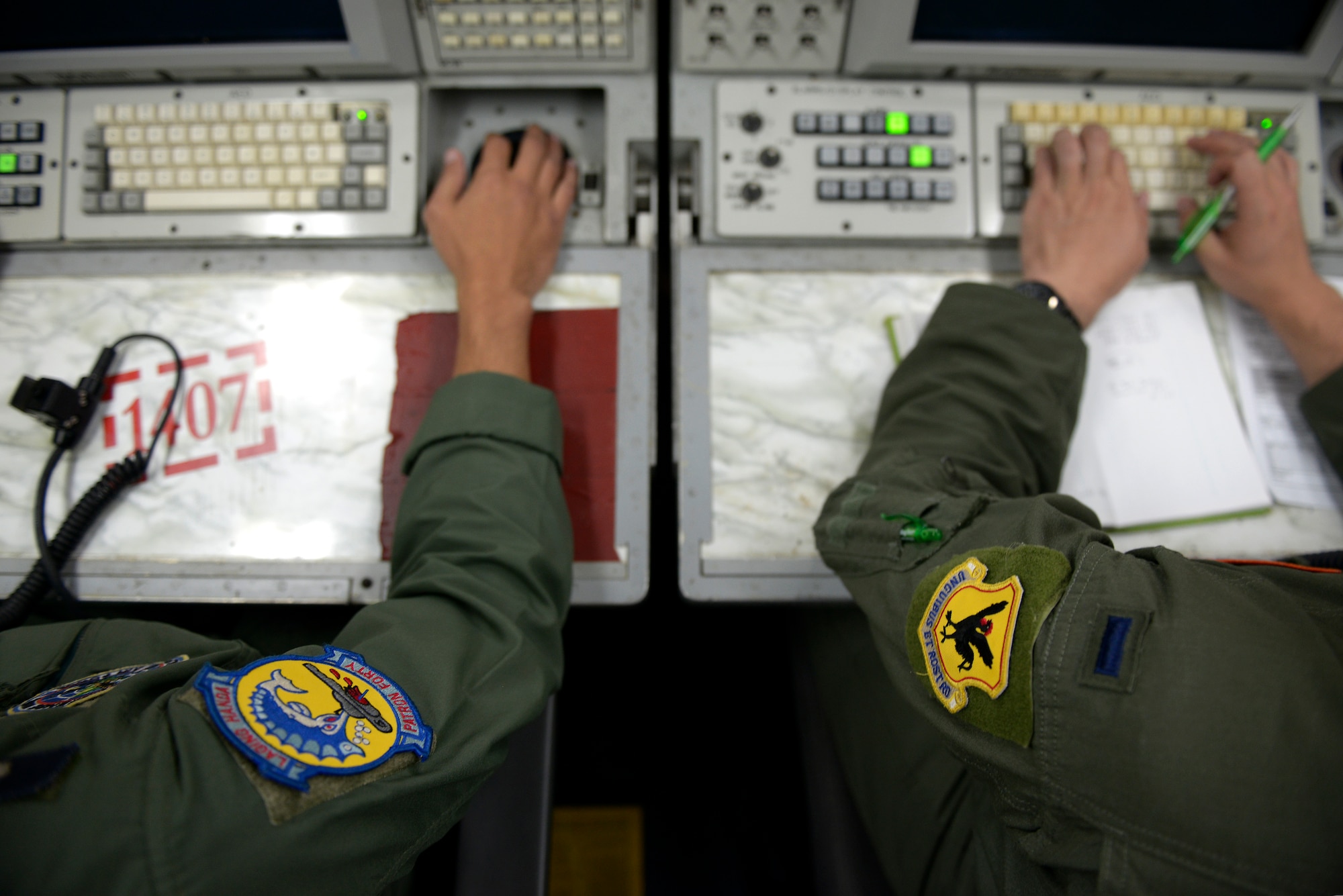 Philippine Air Force (PAF) Maj. Frederick Facia, left, 581st Aircraft Control and Training Squadron commander and air battle manager works alongside U.S. Air Force 1st Lt. Andrew Stokes, 961st Airborne Air Control Squadron air weapons officer, aboard a 961st AACS E-3 Sentry Airborne Warning and Control System (AWACS) aircraft during exercise Balikatan 2015 over the Philippines, April 23. This exercise marks the first time in history that PAF air battle managers have controlled other aircraft while onboard the AWACS. Since the exercise began, April 20, the 961st AACS has integrated 20 PAF weapons controllers during their missions in order to provide them with first-hand experience using the aircraft’s systems. The 961st AACS is stationed at Kadena Air Base, Japan. (U.S. Air Force photo by Staff Sgt. Maeson L. Elleman)
