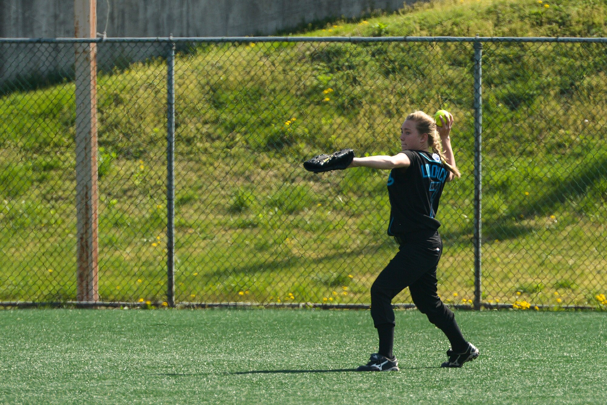Avery Lokowich,daughter of Lt. Col. Luke Lokowich, 5th Reconnaissance Squadron commander and a U-2 pilot, preapres to throw a softball during her softball game April 25, 2015, at Osan Air Base, Republic of Korea. Avery is a freshman who plays for the Osan American High School Cougars softball team. (U.S. Air Force photo by Staff Sgt. Jake Barreiro/Released)