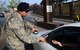 Airman 1st Class Ruben Vega, 51st Security Forces Squadron patrolman, checks an identification card outside the Main Gate May 1, 2015, at Osan Air Base Republic of Korea. Vega was chosen as a Team Osan Spotlight award winner. Individuals who are chosen for this spotlight recognition are distinguished as consistent, superior performers within their squadrons. (U.S. Air Force photo by Staff Sgt. Benjamin Sutton/Released)