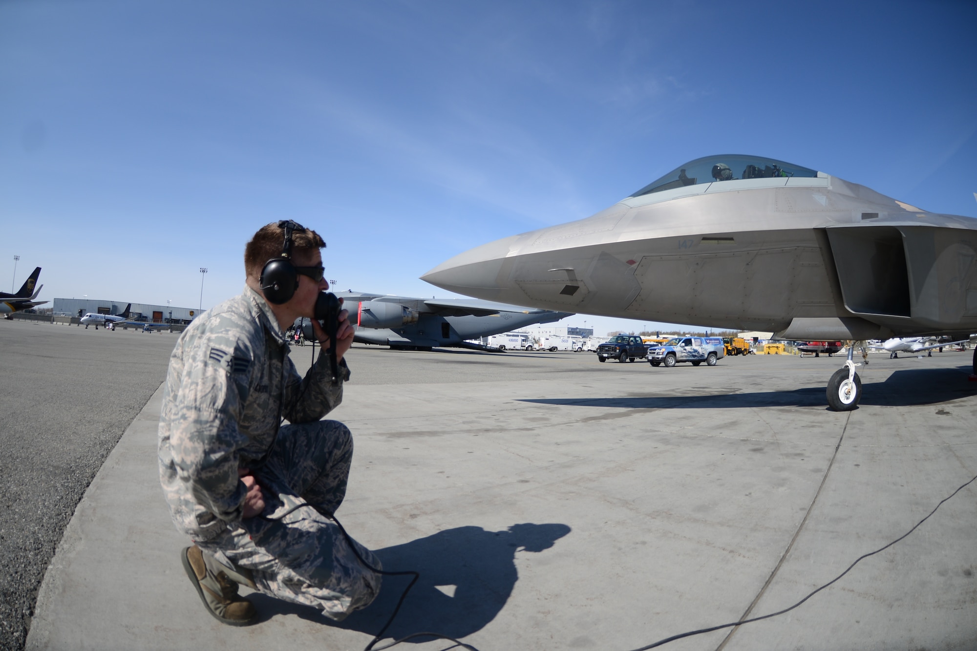 Senior Airman Anton Rozodovskiy, 477th Aircraft Maintenance Squadron F-22 crew chief, communicates with Maj. Caleb Haley, F-22 pilot assigned to the 302nd Fighter Squadron, during the aircraft launch inspection at the Great Alaska Aviation Gathering on Sunday May 3. The Air Force Reserve's 477th Fighter Group took the jet to be a part of the show that included more than 275 vendors and was attended by more than 23,000 visitors. (Air Force Photo/Tech. Sgt. Dana Rosso)